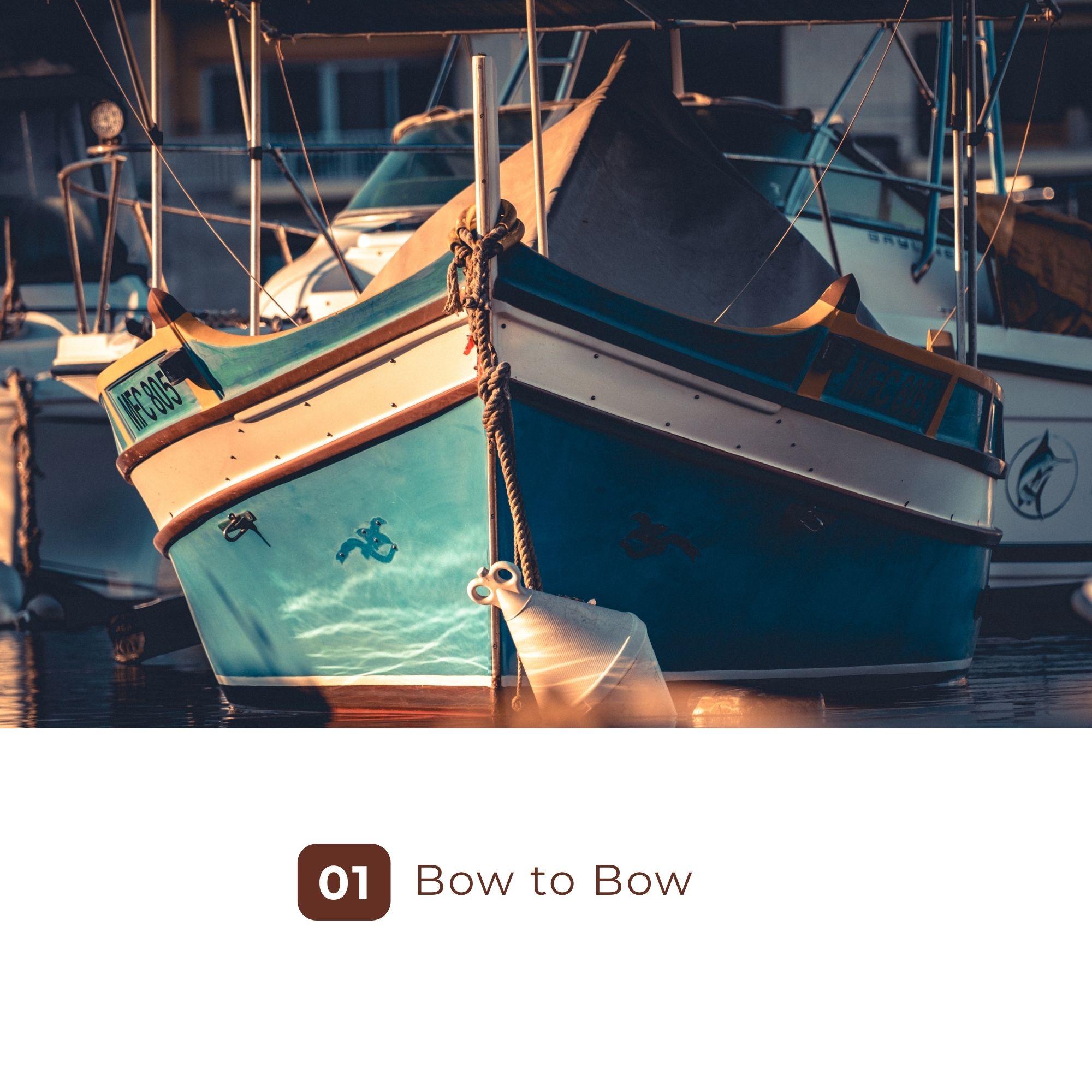 Two turquoise boats moored bow to bow at sunset