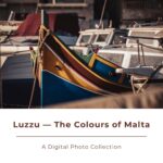 Colorful Maltese luzzu fishing boats moored in harbor