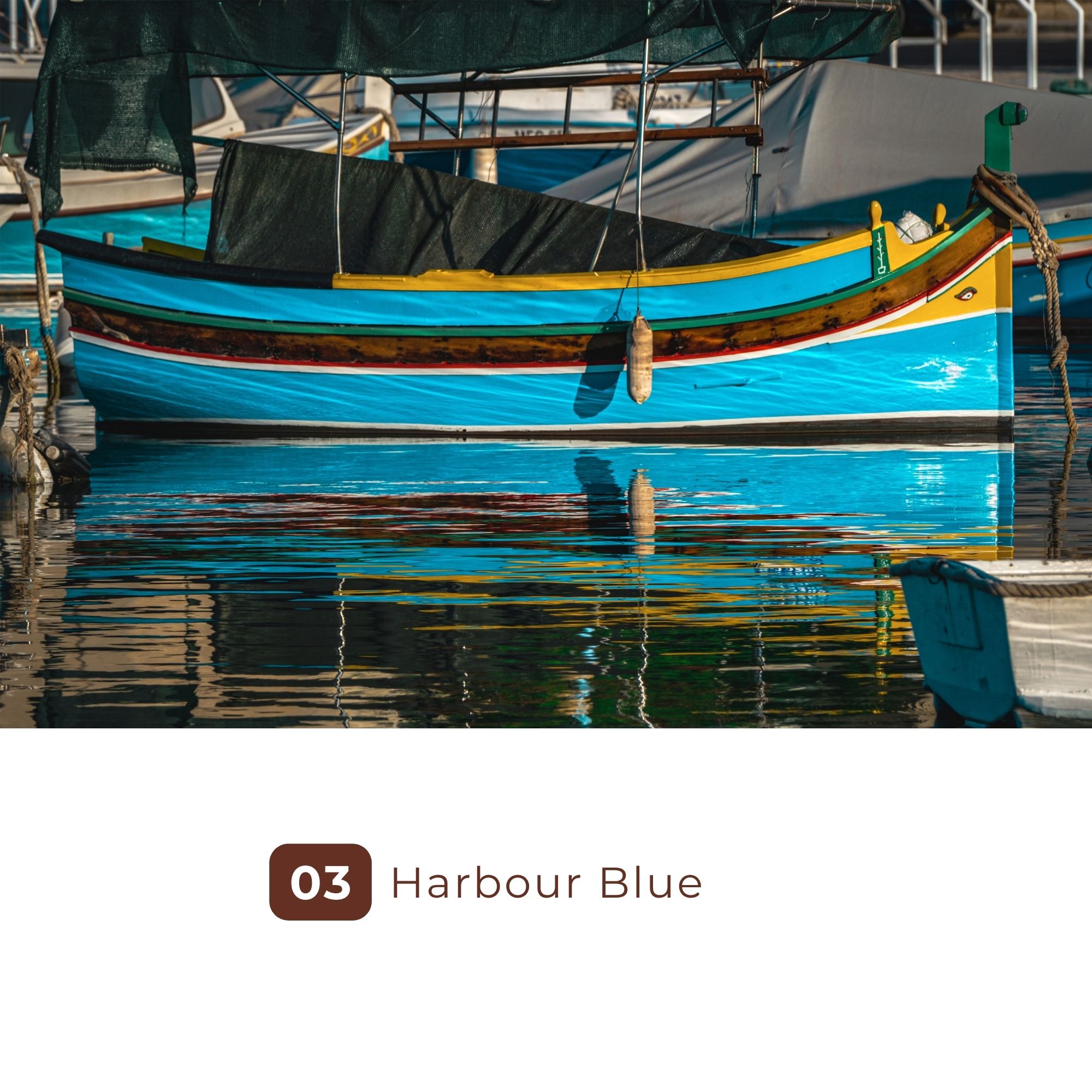Colorful blue fishing boat moored in calm harbor water