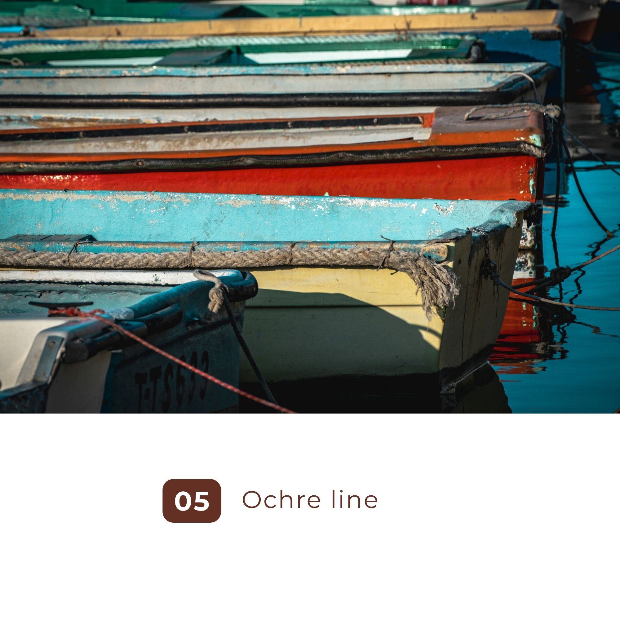 Weathered colorful boats moored closely on calm water