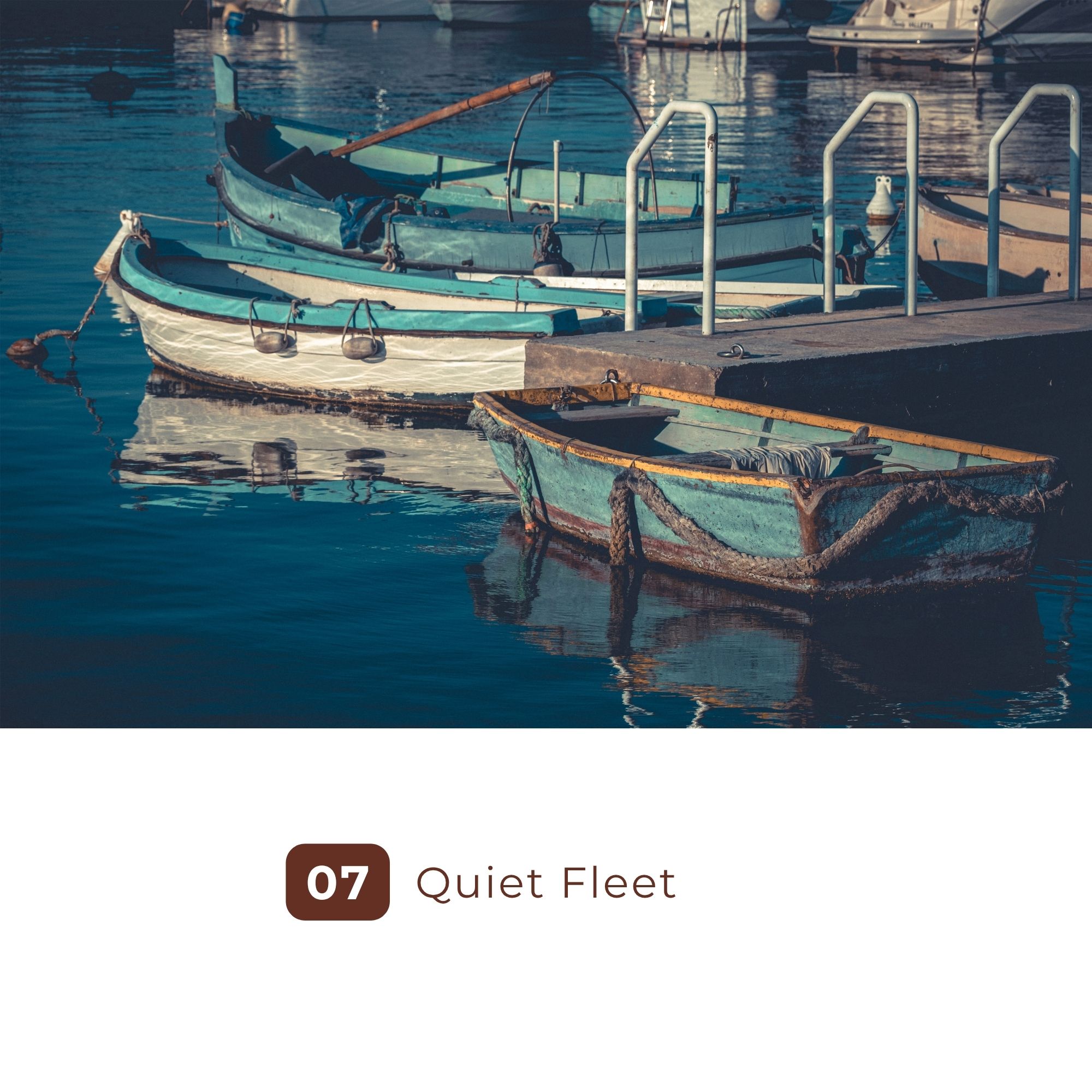Weathered fishing boats moored beside a quiet marina dock