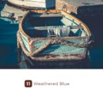 Weathered blue rowboat moored beside a dock