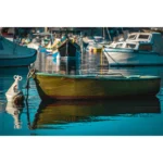 Small yellow rowboat moored in a calm harbor