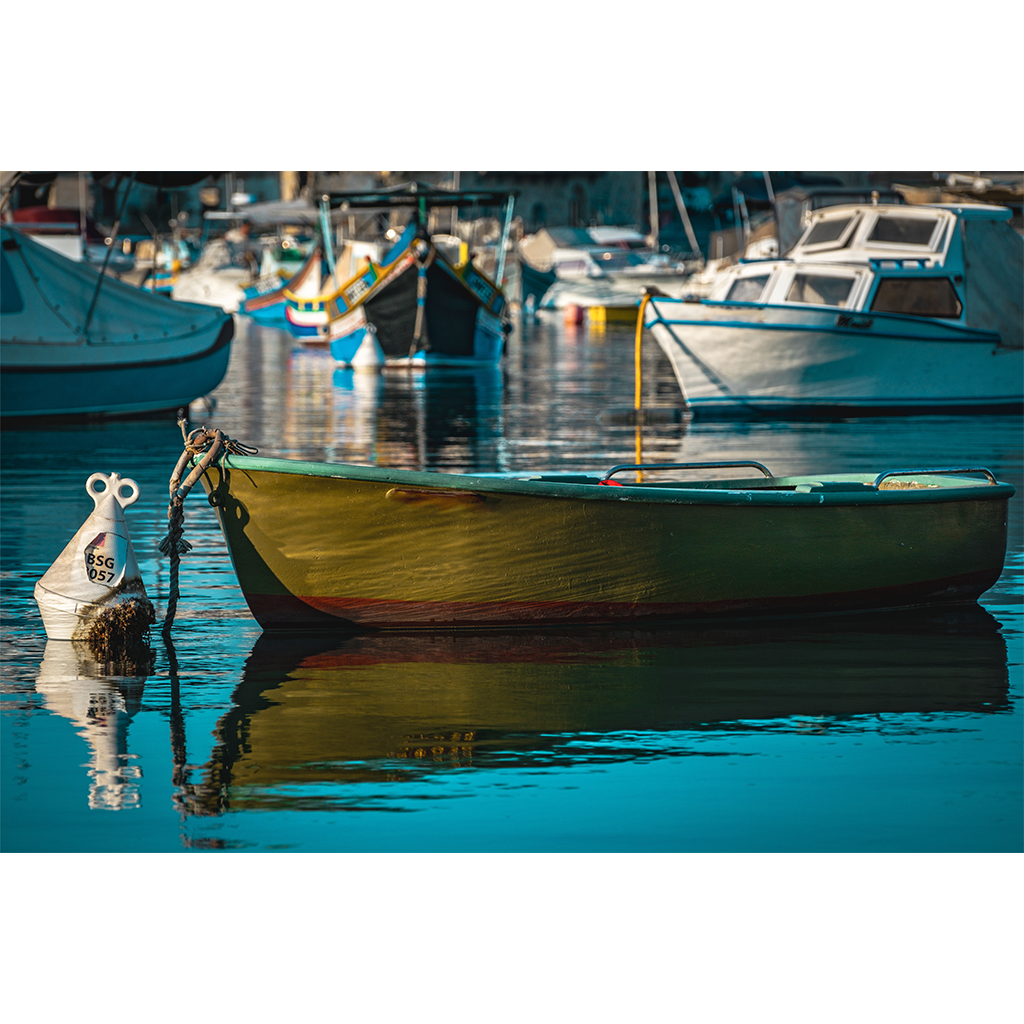 Small yellow rowboat moored in a calm harbor