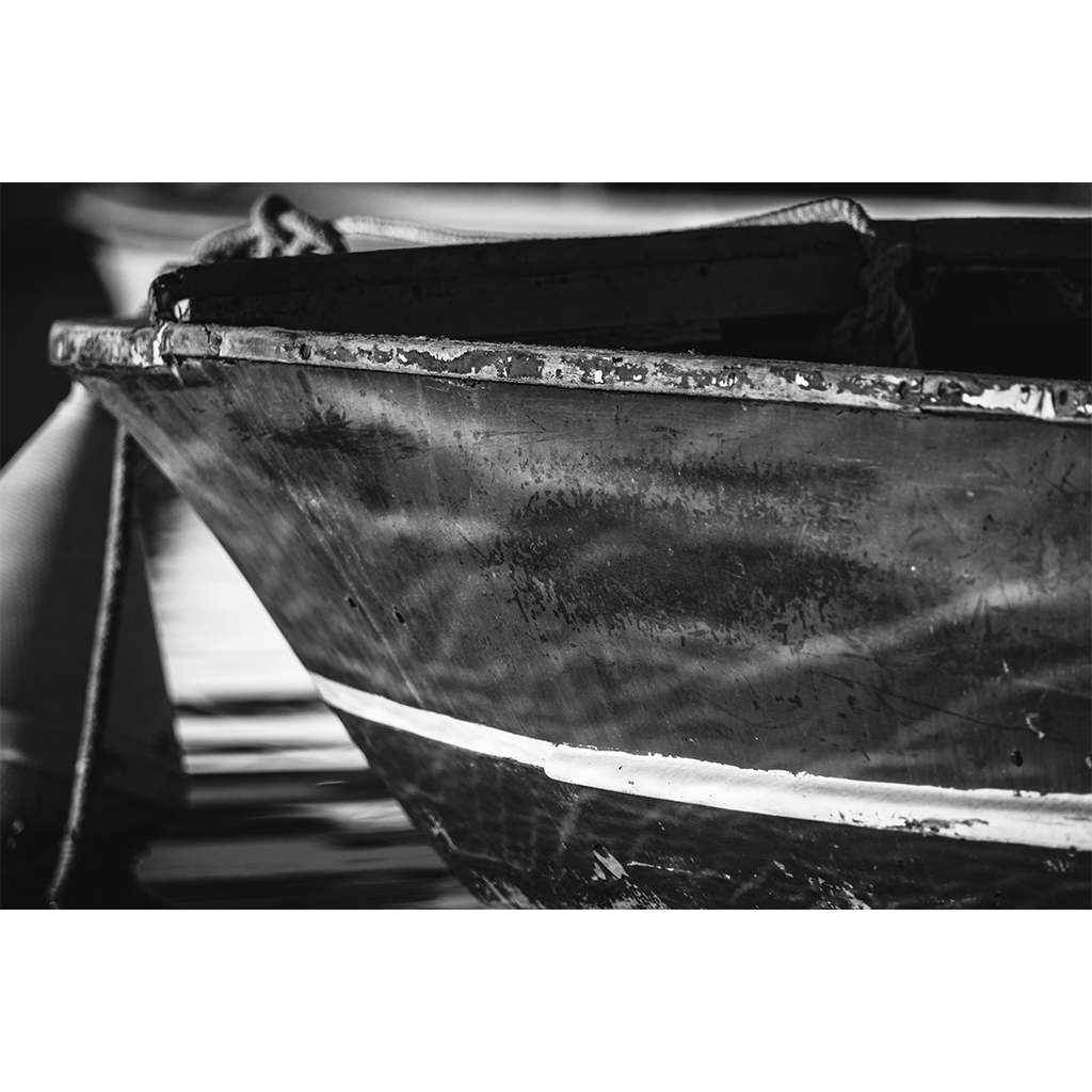 Black-and-white close-up of a weathered wooden boat