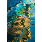 Colorful boats reflected in rippling blue water