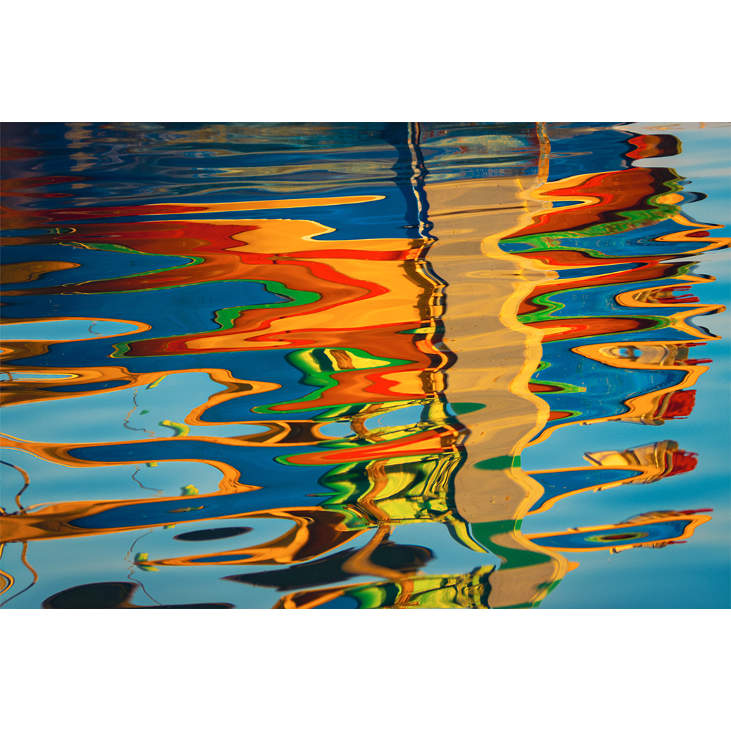 Colorful boats reflected in rippling blue water