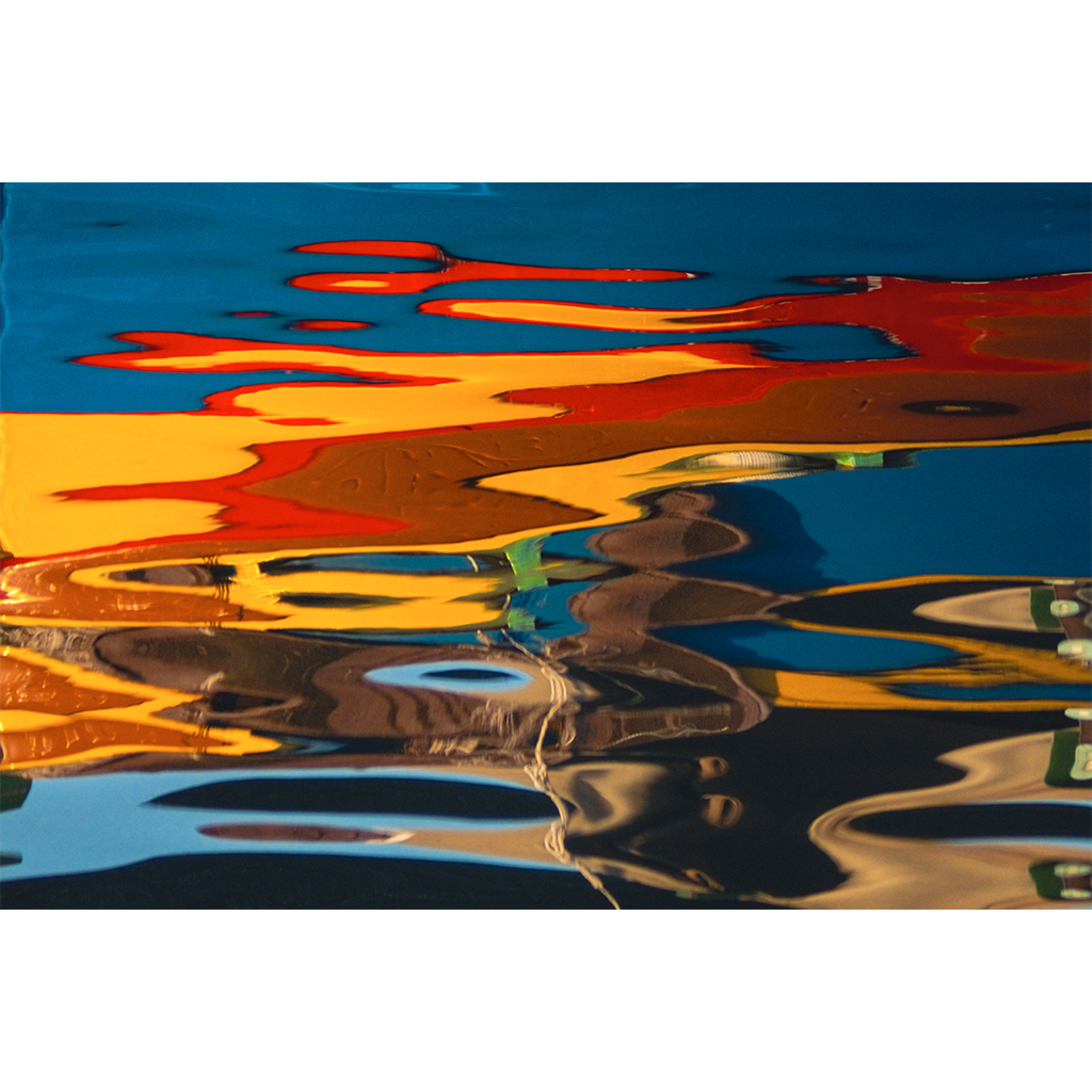Abstract reflections of orange, blue, and yellow on water