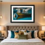Framed boat artwork above elegant tufted bed