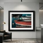 Framed photograph of colorful boats in a modern office
