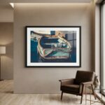 Framed boat photograph above leather chair in modern room