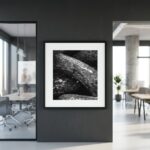 Framed black-and-white rock photograph in modern office