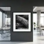 Framed black-and-white rock photograph in modern office
