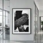 Framed black-and-white abstract photograph in modern office hallway