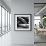 Framed black-and-white rock photograph in modern office