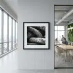 Framed black-and-white rock photograph in modern office