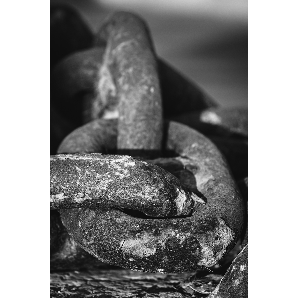 Close-up of weathered metal chain links in black and white