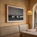 Cozy stone-walled restaurant booth with lighthouse photograph