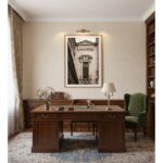 Traditional home office with wood desk and green armchair
