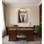 Traditional home office with wood desk and green armchair