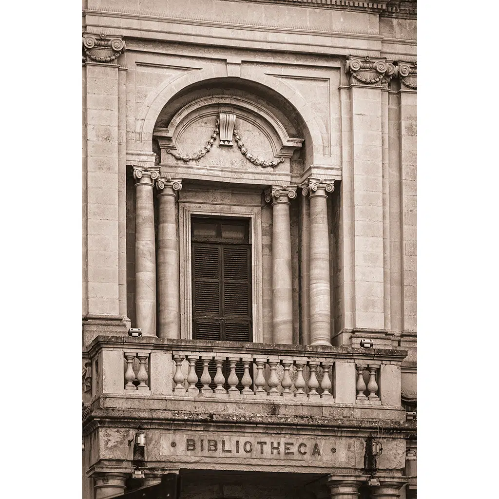 Ornate stone library facade with columns and balcony