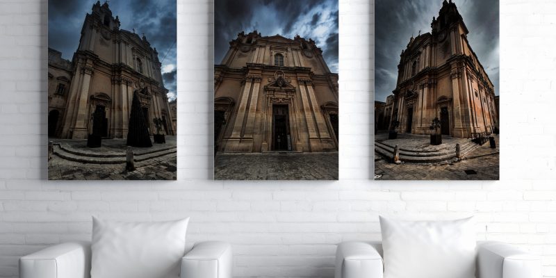 2 white sofas with a hanging 3 canvas set of Mdina Cathedral