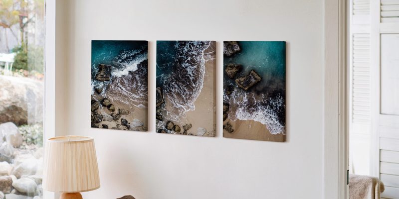 Beach wave triptych artwork above wooden console